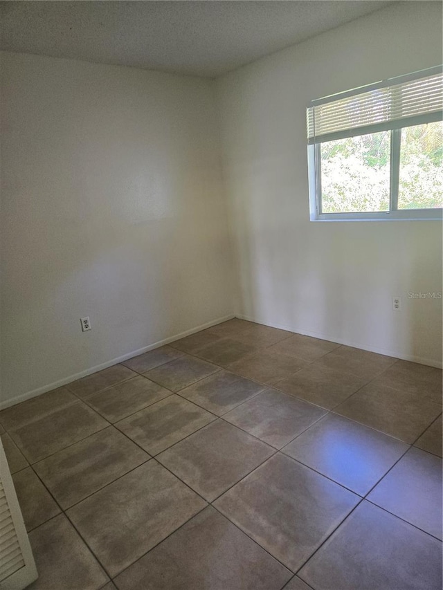 empty room with tile patterned flooring