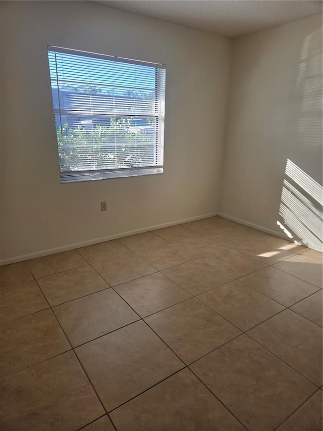 unfurnished room featuring light tile patterned floors