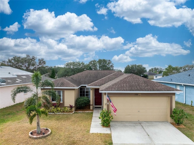 single story home with a front yard and a garage