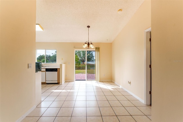 tiled spare room with a notable chandelier, lofted ceiling, and a textured ceiling