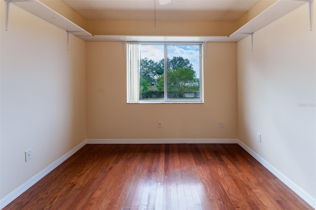 spare room featuring dark hardwood / wood-style flooring