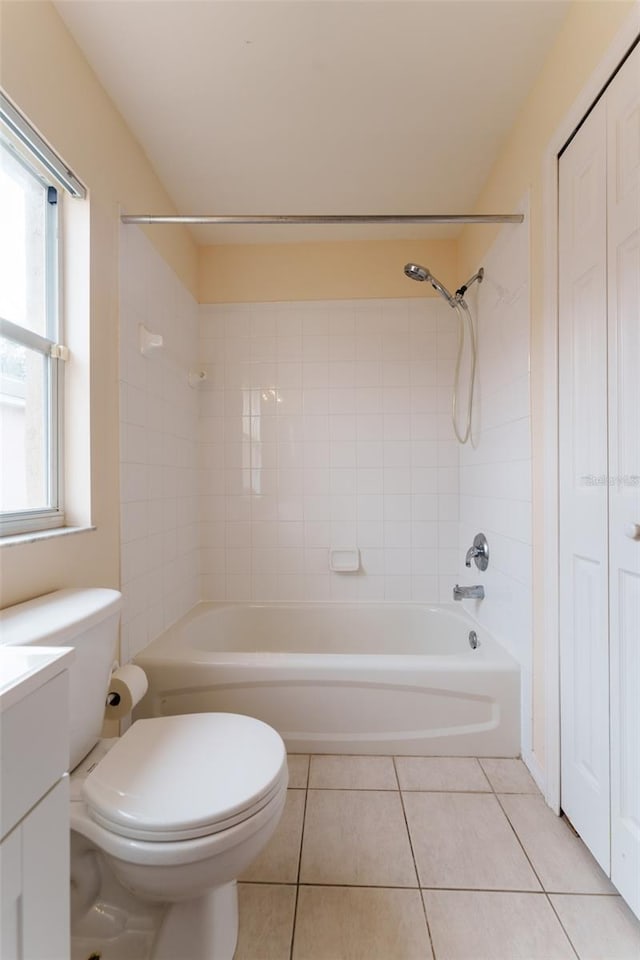 full bathroom with tile patterned flooring, vanity, toilet, and tiled shower / bath combo