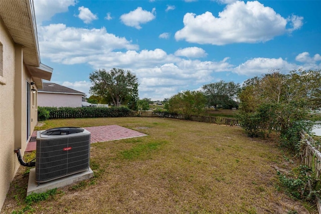 view of yard featuring central air condition unit and a patio