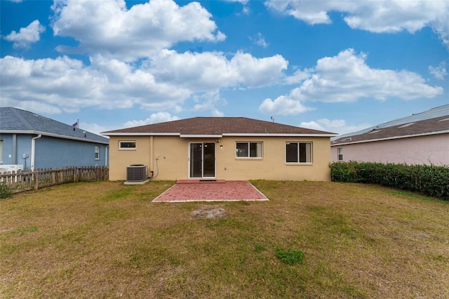 rear view of house featuring a yard, a patio, and cooling unit