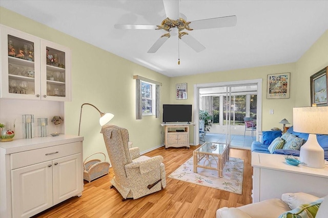 living room featuring ceiling fan and light hardwood / wood-style flooring