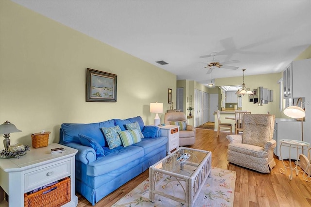 living room featuring ceiling fan and light hardwood / wood-style flooring