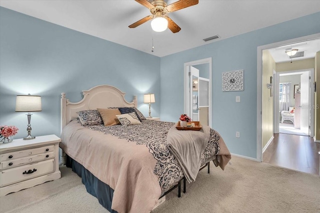 bedroom with light colored carpet and ceiling fan