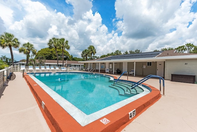 view of swimming pool with a patio