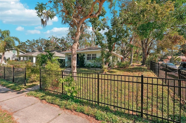 single story home featuring a front lawn