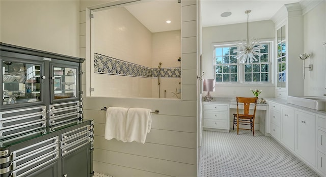 bathroom with an inviting chandelier and vanity