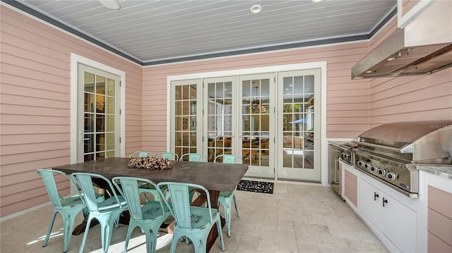 view of patio with area for grilling, a grill, and french doors