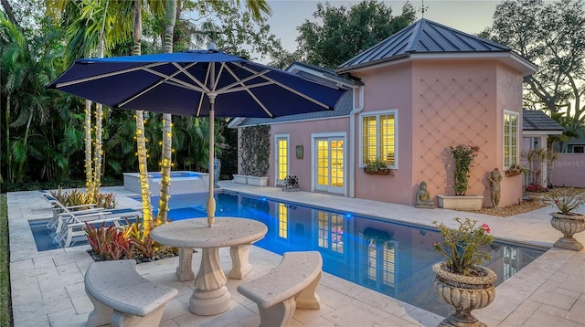 view of pool with a patio area and an in ground hot tub