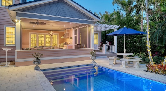 back of property featuring ceiling fan, a pergola, and a patio area