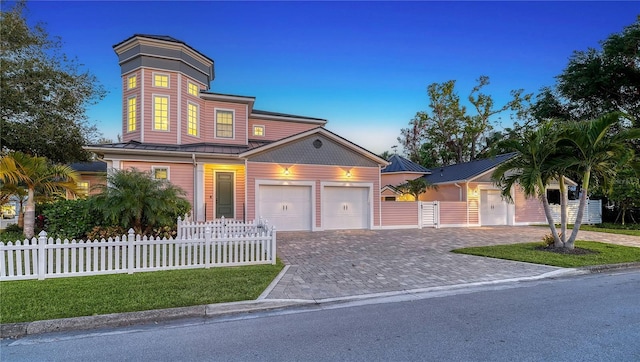 view of front of property with a garage and a yard