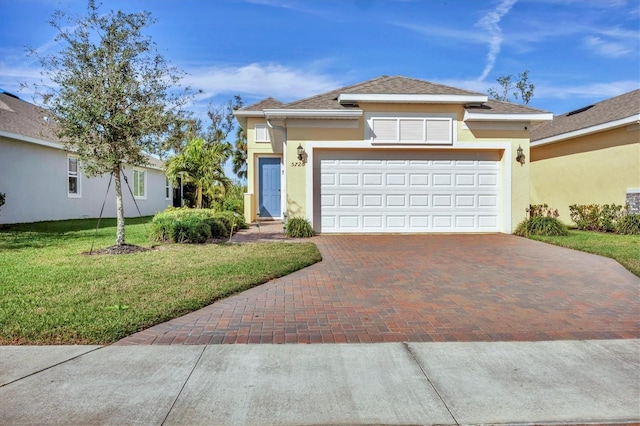 view of front of house with a garage and a front lawn