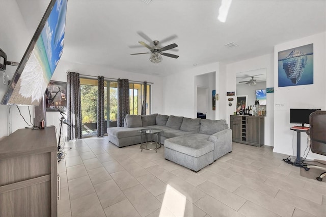 tiled living room featuring ceiling fan