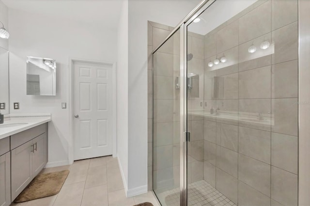 bathroom with tile patterned flooring, vanity, and an enclosed shower