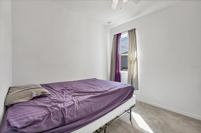 bedroom with ceiling fan and light carpet