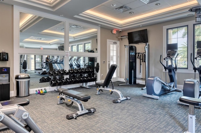 workout area featuring a tray ceiling