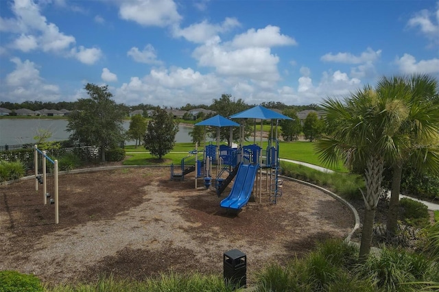 view of jungle gym with a lawn and a water view