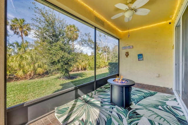 unfurnished sunroom featuring a wealth of natural light and ceiling fan