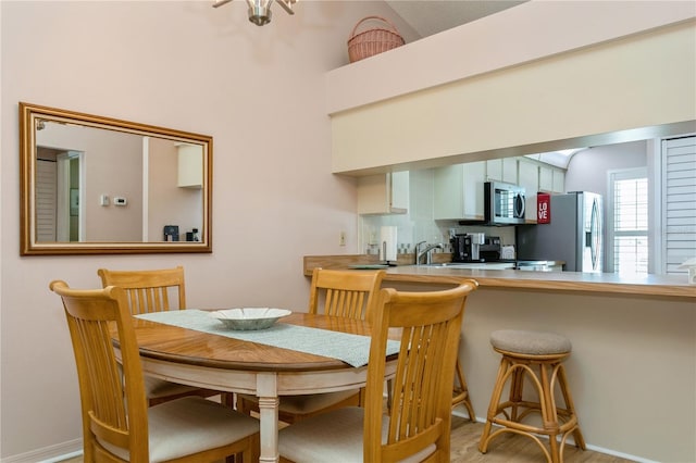 dining area featuring sink and light hardwood / wood-style floors