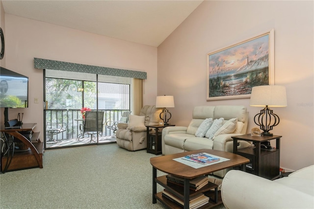 living room featuring carpet floors and lofted ceiling