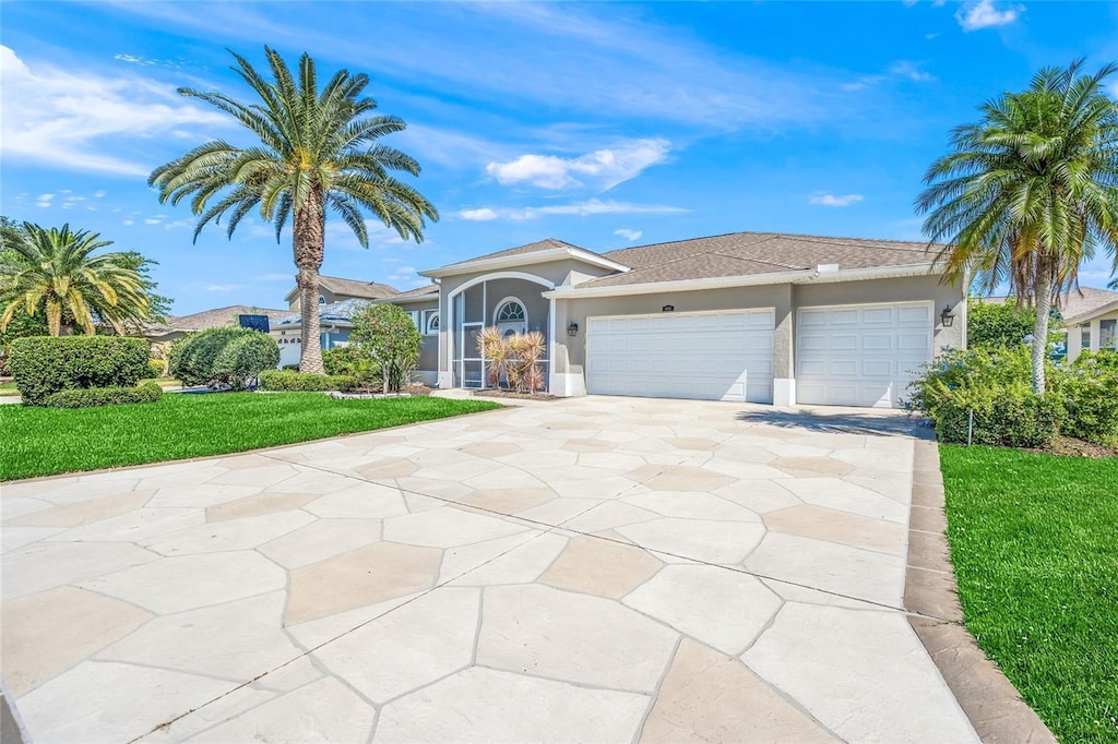 view of front facade with a front yard and a garage