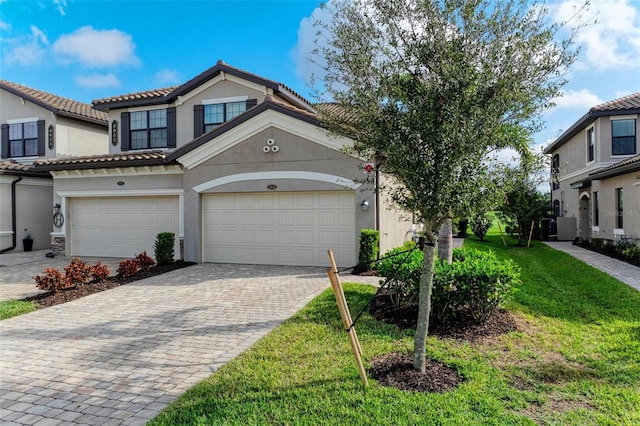 view of front of home featuring a front yard and a garage