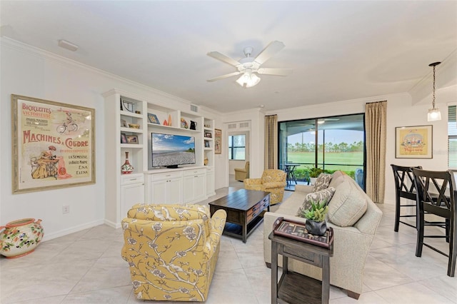 tiled living room featuring built in features, ceiling fan, and crown molding