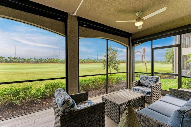 sunroom featuring ceiling fan