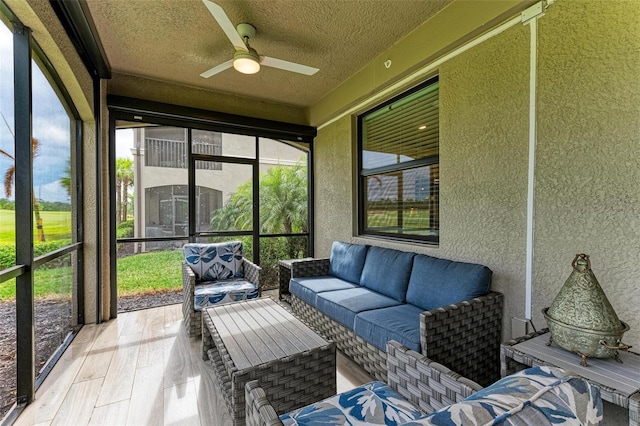 sunroom featuring ceiling fan