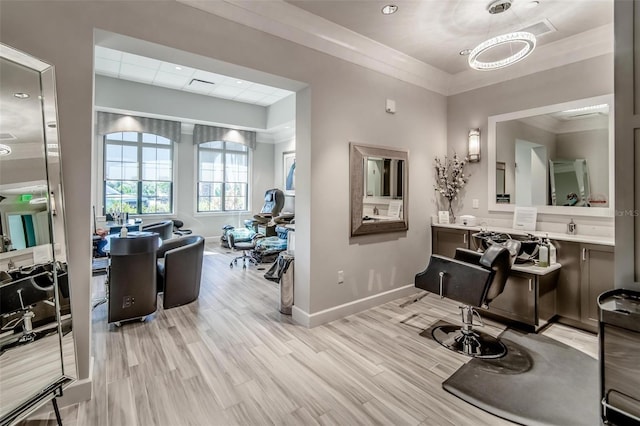 interior space featuring hardwood / wood-style flooring, vanity, and ornamental molding