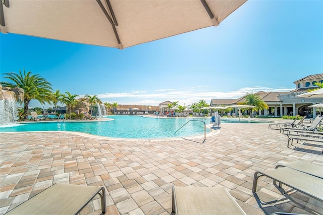 view of swimming pool featuring pool water feature and a patio area