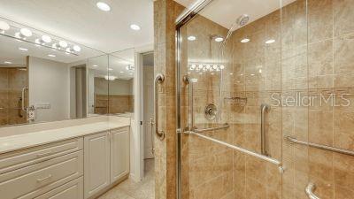 bathroom featuring a stall shower and vanity