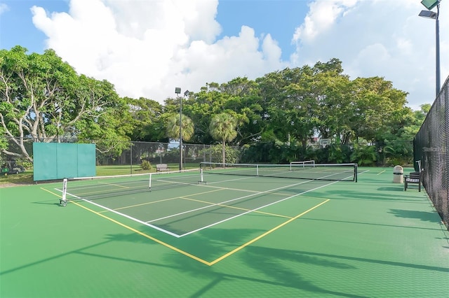 view of tennis court with fence