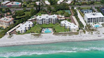 aerial view with a water view and a beach view