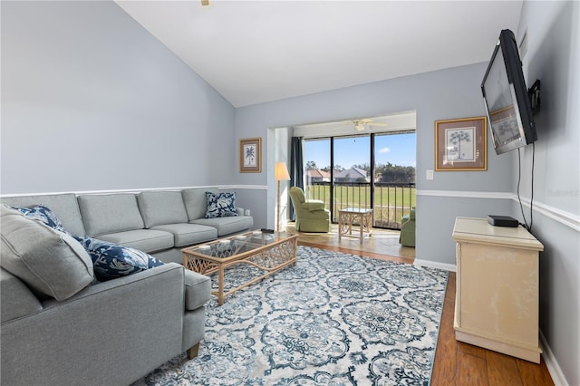 living room featuring ceiling fan, hardwood / wood-style floors, and lofted ceiling