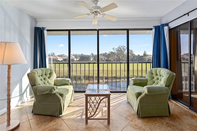 sunroom / solarium featuring ceiling fan