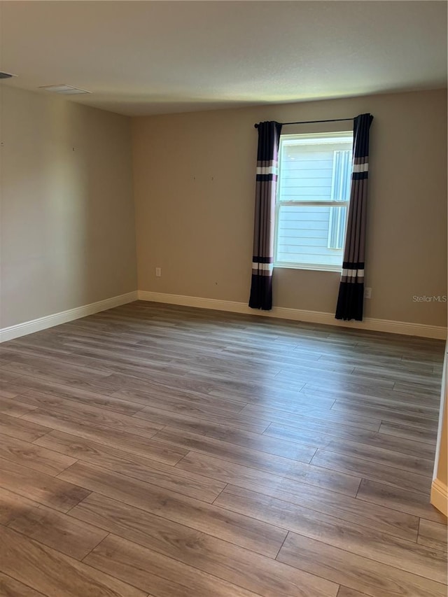 spare room featuring light wood-type flooring