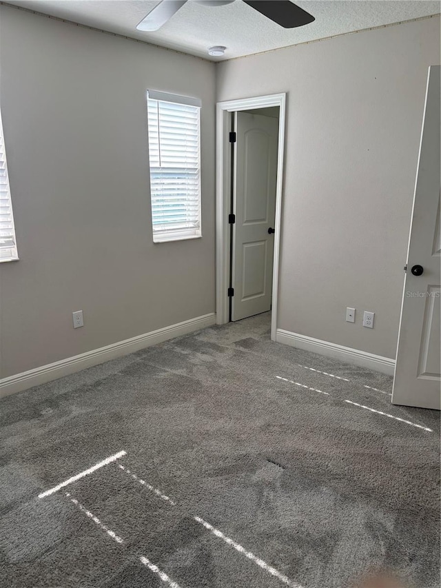 unfurnished room featuring ceiling fan and carpet