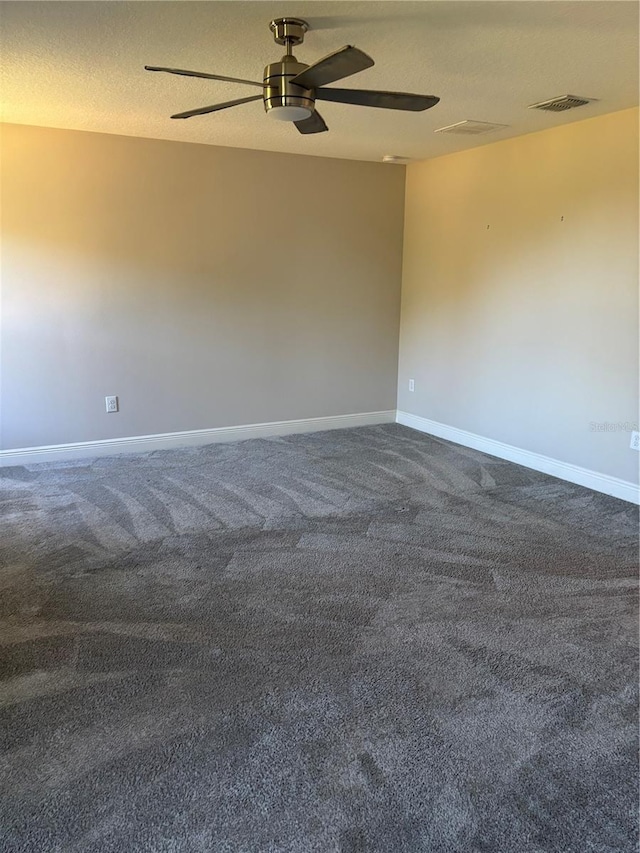 carpeted spare room featuring a textured ceiling and ceiling fan