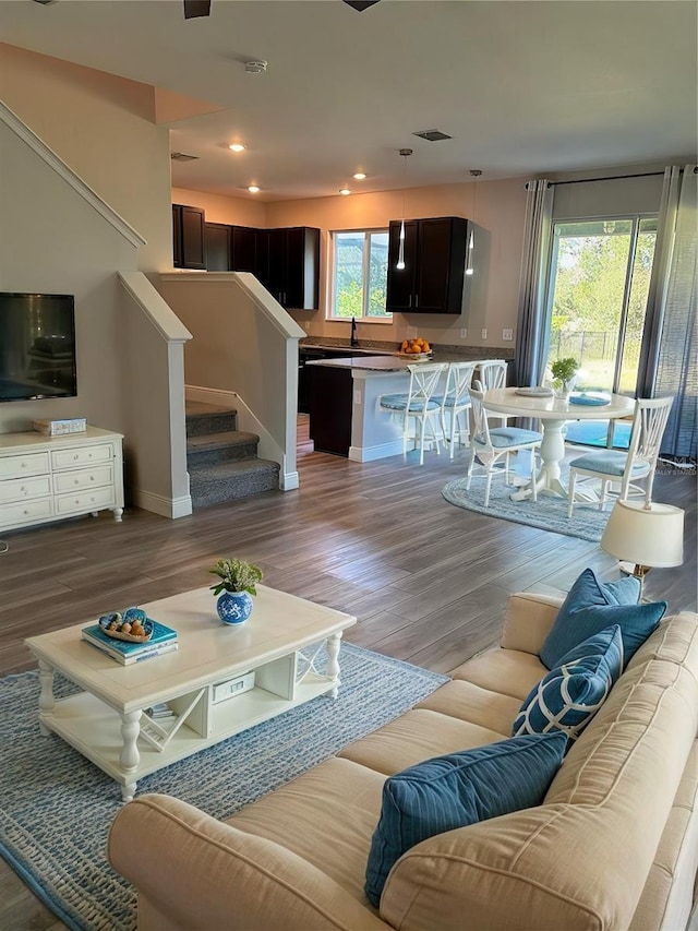 living room featuring light hardwood / wood-style flooring and sink