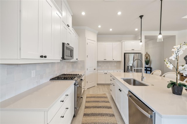 kitchen with sink, pendant lighting, a center island with sink, and appliances with stainless steel finishes