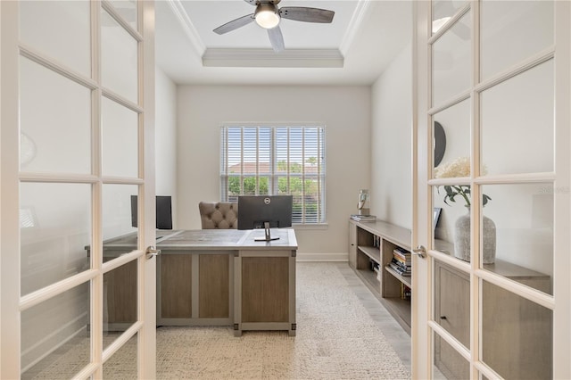 home office with ceiling fan, a raised ceiling, ornamental molding, and french doors