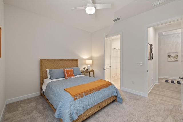 bedroom featuring carpet flooring, ceiling fan, and ensuite bathroom