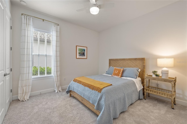 bedroom featuring light colored carpet and ceiling fan