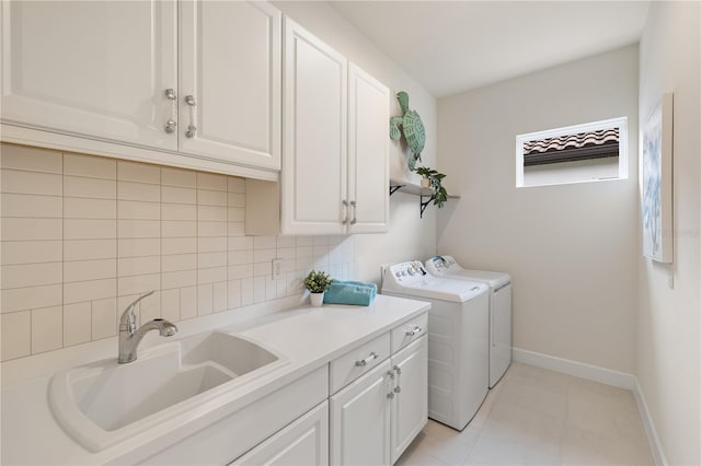 laundry area with washer and dryer, sink, light tile patterned floors, and cabinets