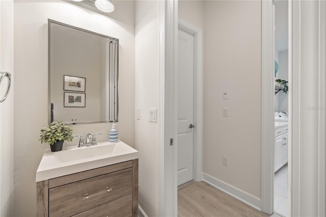 bathroom featuring wood-type flooring and vanity