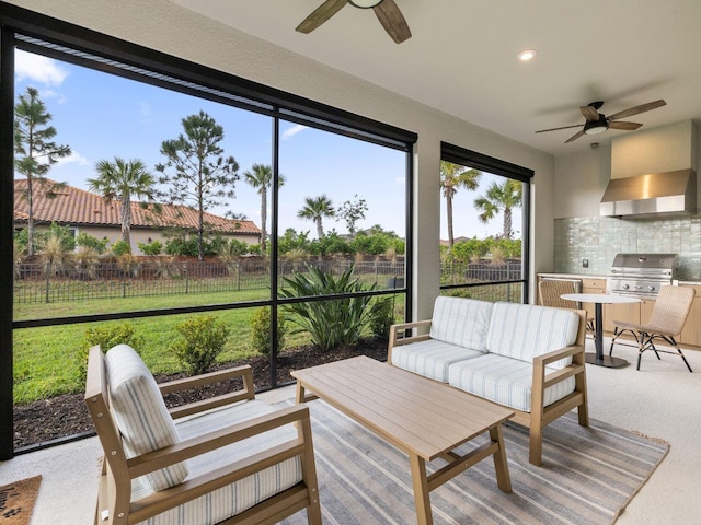 sunroom featuring ceiling fan